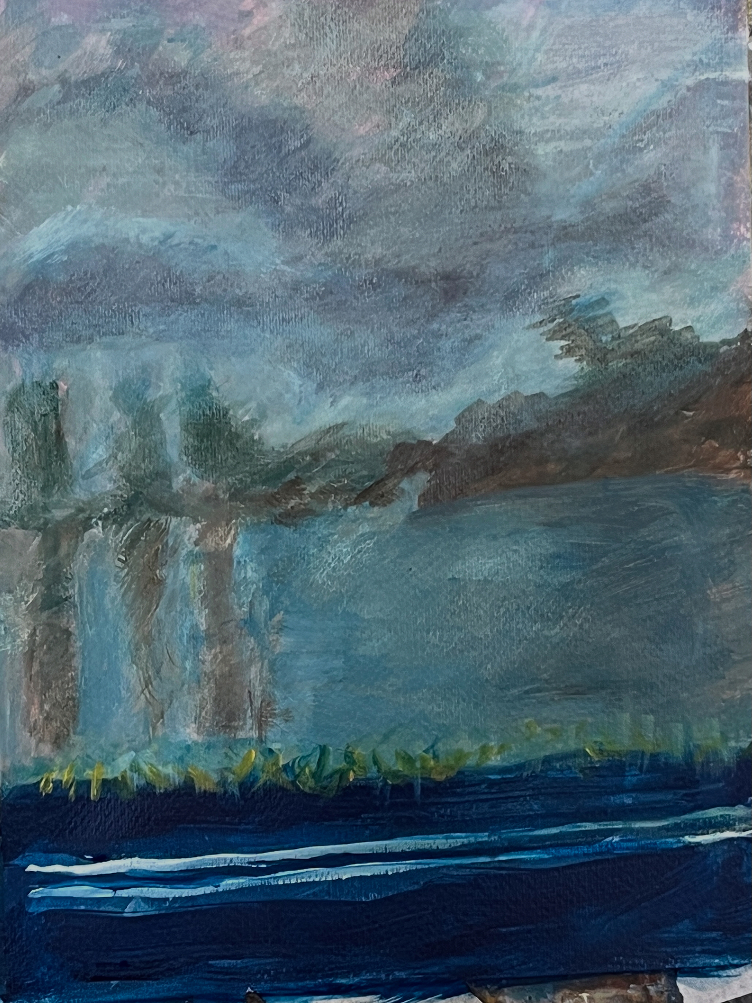 Moody seascape with soft blue tones and blurred horizon.