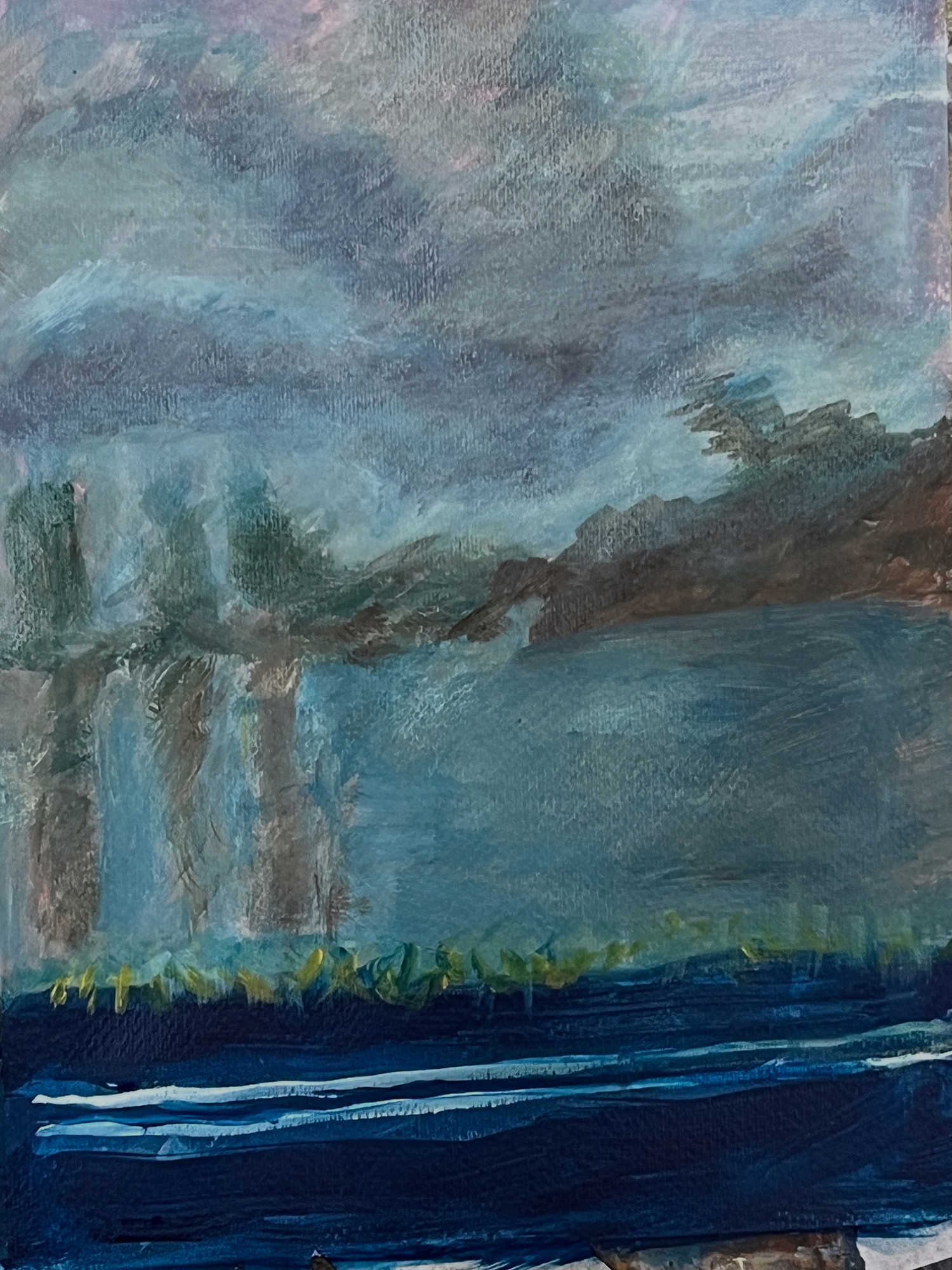 Still life on a windowsill with objects and a rain-streaked window looking out onto green landscape.